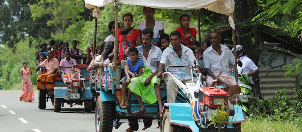 indian families travelling on open tractors, by Insider Tours